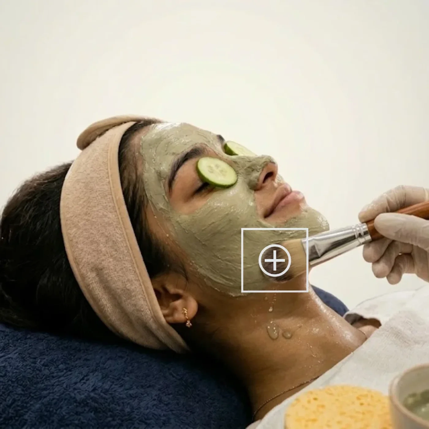 A clay mask applied with a brush during a facial