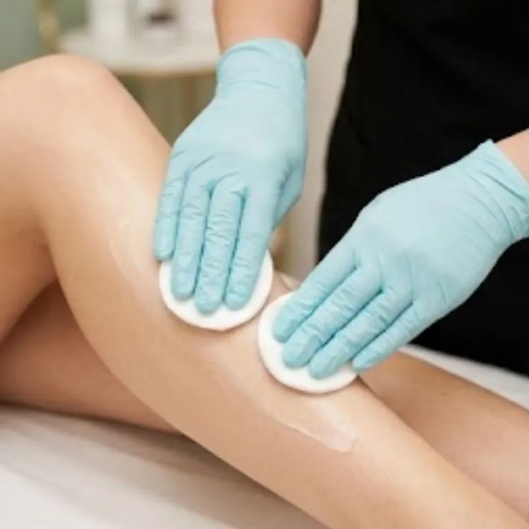 Skin being cleansed before a leg wax