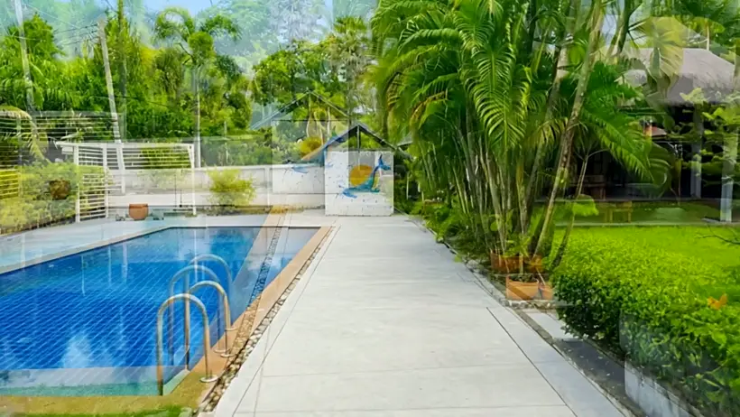 The full length of the pool with the garden behind