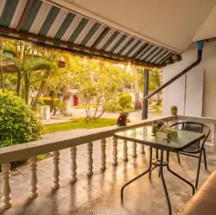 The balcony of Cottage C at sunset, looking onto the garden