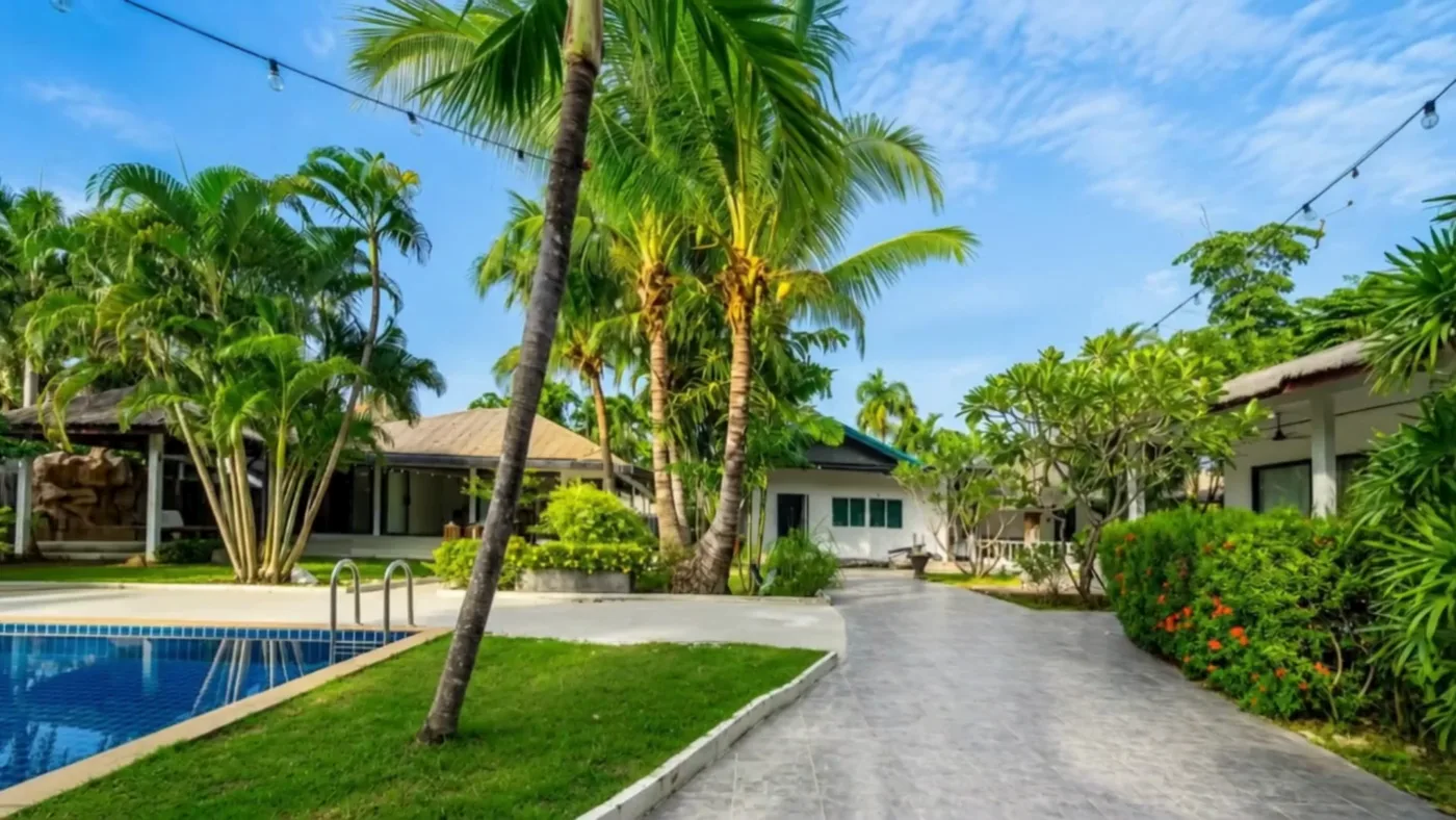 The garden at Naya: palms over the cottages and the lawn